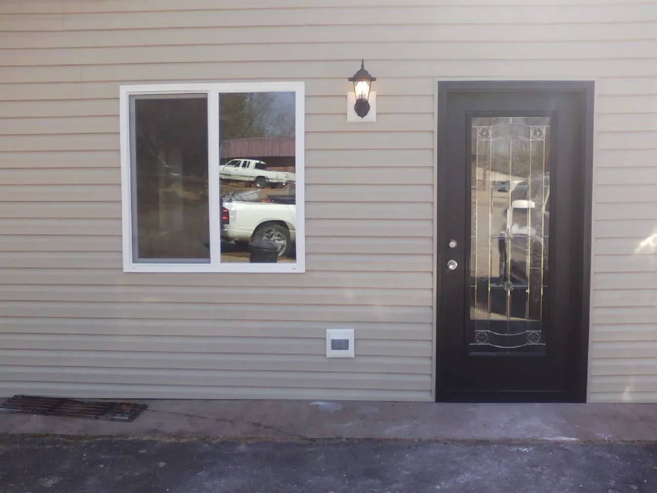 New siding, window and entry door on the side of an addition in Andersonville